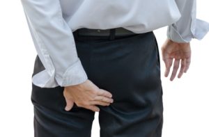 man touching pant